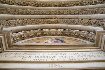 Arches Above Entrance to Gothic Church with Reliefs and Latin Inscription