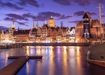 Old harbour crane and city gate Zuraw in old town of Gdansk at night, Poland
