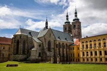 Naklejka premium Close-Up of Premonstratensian Monastery with Central Church, Green Lawn, Dramatic Stormy Clouds