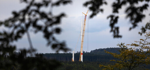 a wind turbine construction site in a forest panorama