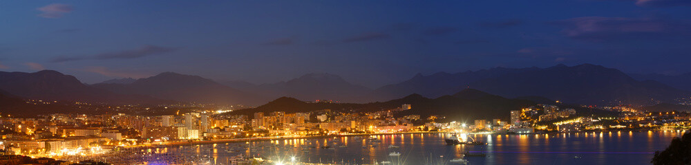 The houses of Ajaccio city and its marina at night , France, Corsica island.