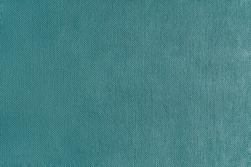 Texture background of bright green velours fabric. Textile structure, cloth surface, weaving of jacquard material closeup. Upholstery, curtains, backdrop, wallpaper.