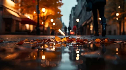 Foto op Canvas Autumn yellow leaves fall on wet rainy pavement in evening city blurred light © Aleksandr