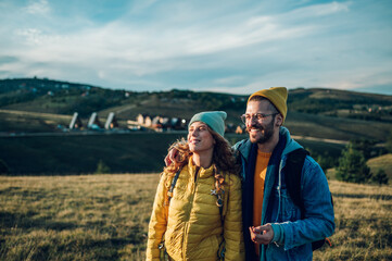 Couple of hikers walking on a mountain trail during their vacation.