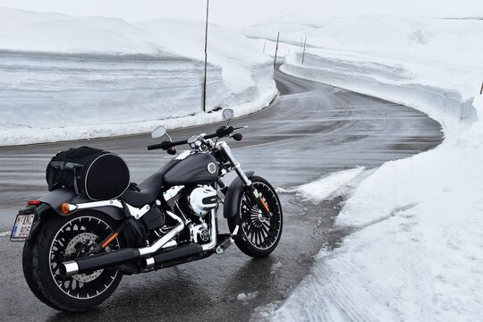 Harley Davidson on snowy road in Austria Alps on May 2019