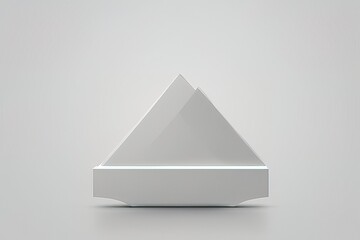3 d rendering white triangle shape in light on a white background3 d rendering white triangle shape in light on a white backgroundwhite triangle on a gray podium