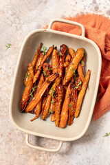 Roasted carrots with thyme, garlic, lemon and honey on baking tray