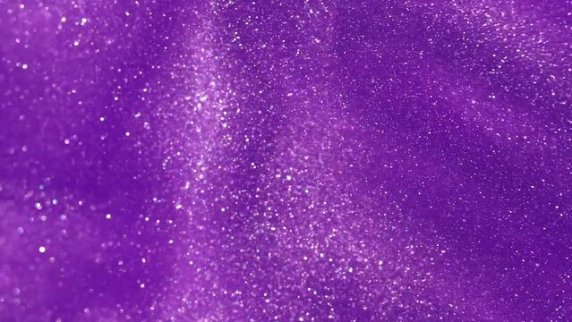 Abstract moving backgrounds of glistering particles in purple colored fluid. Bright Glittering dust particles floating in liquid. Magic dust waves. 