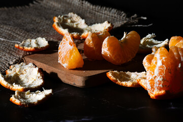 Close-up of mandarin segments surrounded by peels.