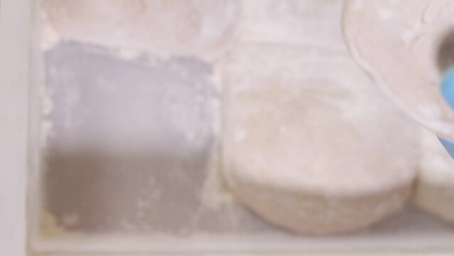 Senior professional chef kneading floured dough at bakery, mature retiree enjoying hobby making homemade bread using traditional recipe isolated on black background close up 4k footage