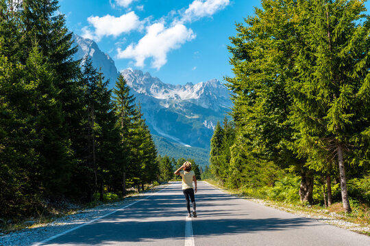 A young girl walking on the road in the Valbona valley, Theth national park, Albanian Alps, Valbona Albania