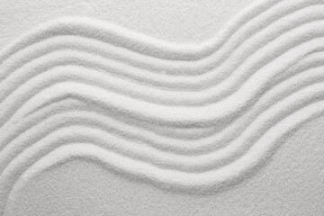 Fototapeta na wymiar White sand with pattern as background, top view. Concept of zen and harmony