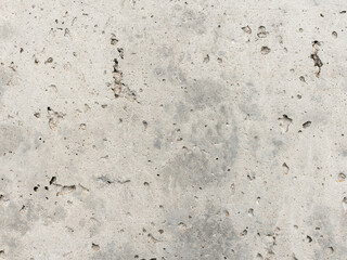 Concrete texture with outgassing holes on the surface. The material close up can be used as a background. The structure has pores and voids.