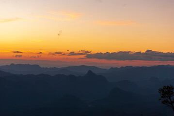 Scenic view dramatic beautiful sunset sky. Natural Sunset Sunrise on meadow silhouette shadow dark land. Vibrant dramatic sky on sunset, dawn, sunrise in Countryside. Landscape Colorful Sky At Sunset