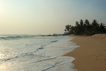 Beach with golden sand and blue ocean water on most popular unawatuna