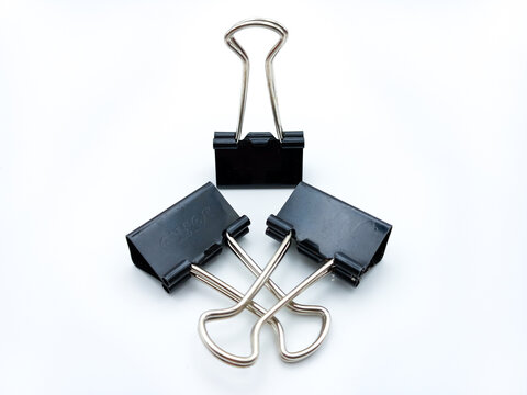 Three Binder Clips Isolated On White Background. One Standing And Two Laying