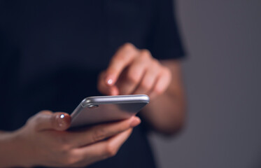 Hand holding smartphone with using social media.