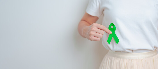 Woman having liver pain with green ribbon. Liver Cancer October awareness month, Tumor, Jaundice,...