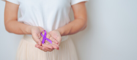 Woman holding purple Ribbon for Violence, Pancreatic, Esophageal, Testicular cancer, Alzheimer,...