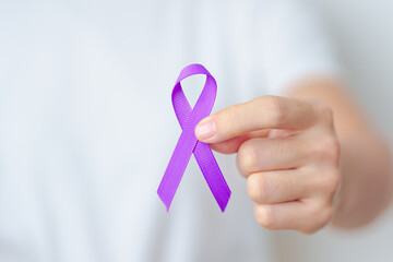 Woman holding purple Ribbon for Violence, Pancreatic, Esophageal, Testicular cancer, Alzheimer,...