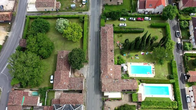 Drone shot, drone video, drone flight, aerial view, flight over the historic old town of Monpazier, most beautiful village in France, central market square and church, camera pan from the street to