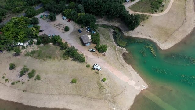 Drone shot, drone video, drone flight, aerial view, flight over the reservoir, Sant Antoni bathing lake, view of the mountains of the southern Pyrenees, camper van wild camping on the beach Lleida
