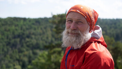 Portrait, close-up. a white elderly man and hiking in the woods, for a healthy lifestyle. The face...