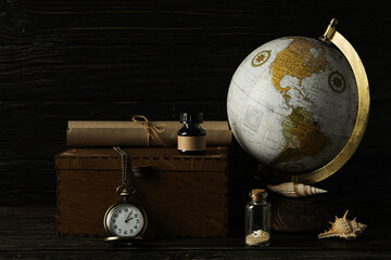 Columbus Day. Globe with a pocket watch on a dark background