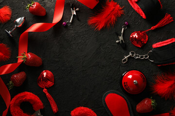 A collection of sex toys on a dark background.