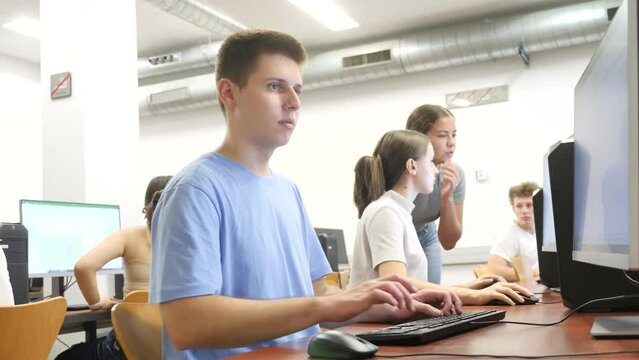 Portrait of male student at computer in university computer class
