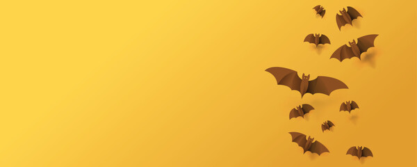 Happy Halloween banner background with paper bats flying on orange background