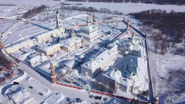 Aerial view in winter of the old Epiphany Staro-Golutvina monastery on the outskirts of the city of Kolomna and residential areas in the distance, Russia.