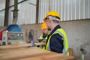 Worker are working at lumber yard in Large Warehouse. Worker are  working.on woodworking machine, lumber and Inventory check at Storage shelves in lumberyard.