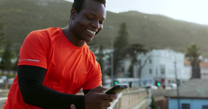 Runner black man, phone and texting outdoor with smile, reading and laugh for comic meme on urban rooftop. Guy, smartphone and happy for contact, video and social media with training in metro cbd