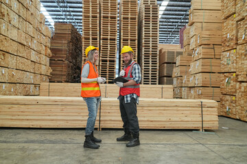 Worker in a timber and lumber warehouse. Product acceptance and quality control. worker doing warehouse inventory check.