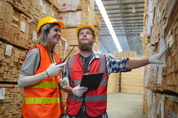 Worker in a timber and lumber warehouse. Product acceptance and quality control. worker doing warehouse inventory check.