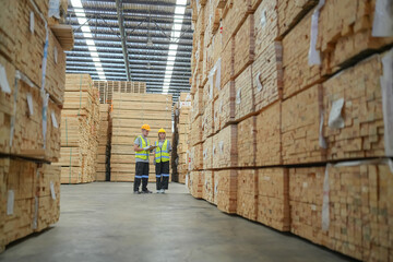Woman with checklist in a timber and lumber warehouse. Product acceptance and quality control