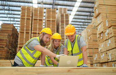 Warehouse worker working at lumber yard in Large Warehouse. Worker are  Inventory check at Storage shelves in lumberyard.