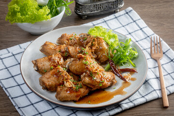 Fried chicken with tamarind sauce on wooden table