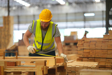 Industrial factory employee working in wooden manufacturing industry