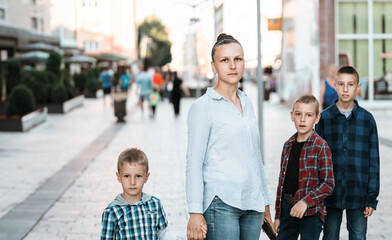 woman with children walks down the street