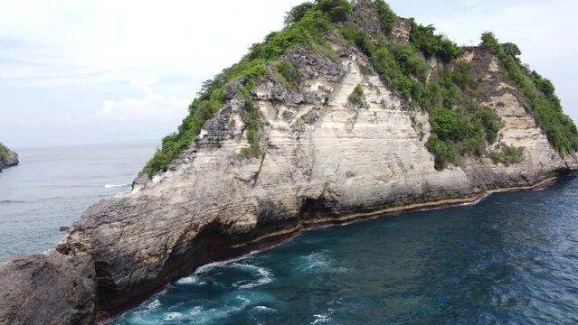 limestone seamount rock formation, atuh Beach Nusa Penida Island Indonesia, aerial establish