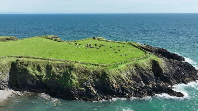 Coast of Ireland Aerial static of Dunabrattin Head Copper Coast Waterford with waves crashing on the rocks on a perfect summer morning