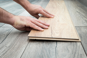 replacement of damaged laminate flooring. Renovation in the apartment. Choice of parquet. Close up...