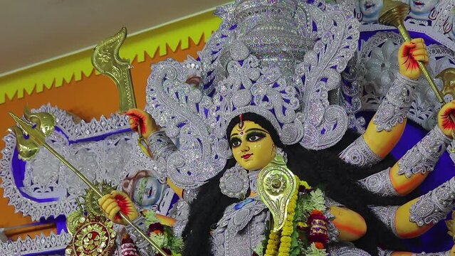 Idol of goddess durga being worshipped during famous bengali indian festival of durga puja. Durga is hindu deity with different weapons and religious items in ten hands. she is treated as mother.