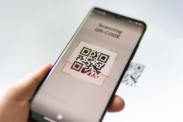 Scanning QR code with mobile smart phone. all graphics on the screen are made up.