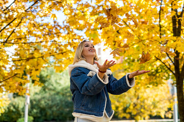 smiling young woman enjoy sunny weather at autumn park