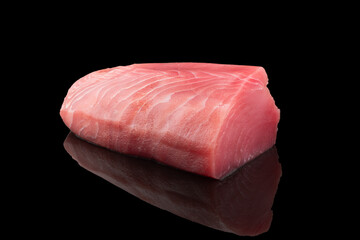 Yellow fin tuna steak isolated on black background. Fresh rare tuna steak isolated. Raw yellowfin tuna fillet texture. Background fresh fish meat. Top view of slices of tuna meat. - obrazy, fototapety, plakaty