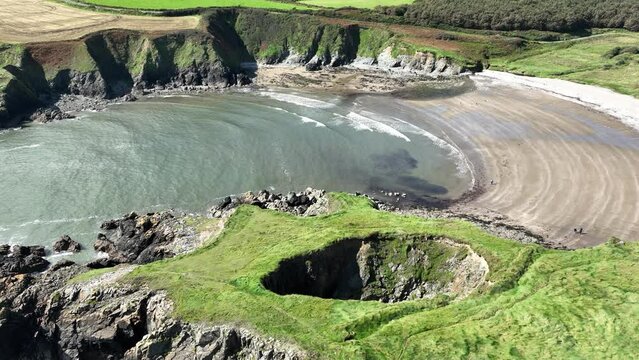 Drone static view of the large blowhole at Kilmurrin Cove Copper Coast Waterford Ireland one of the wonders of nature