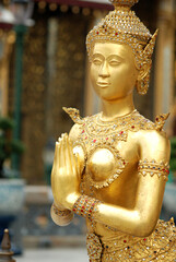 Angel statues inside the Grand Palace, Wat Phra Kaew, Thailand. Beautiful works of art. Sparkling gold color